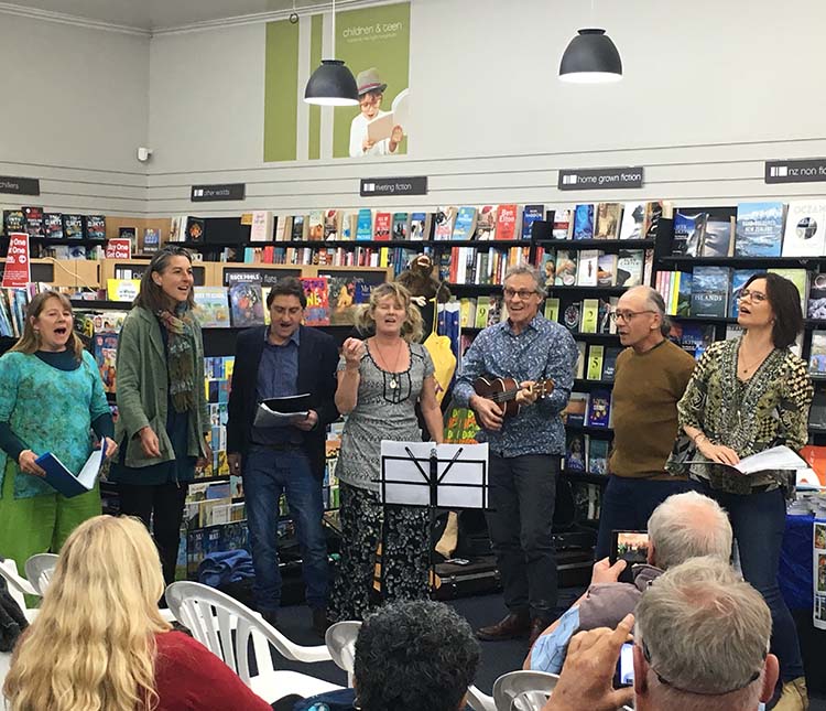 Group of people singing and playing instruments in Marston Moor bookstore